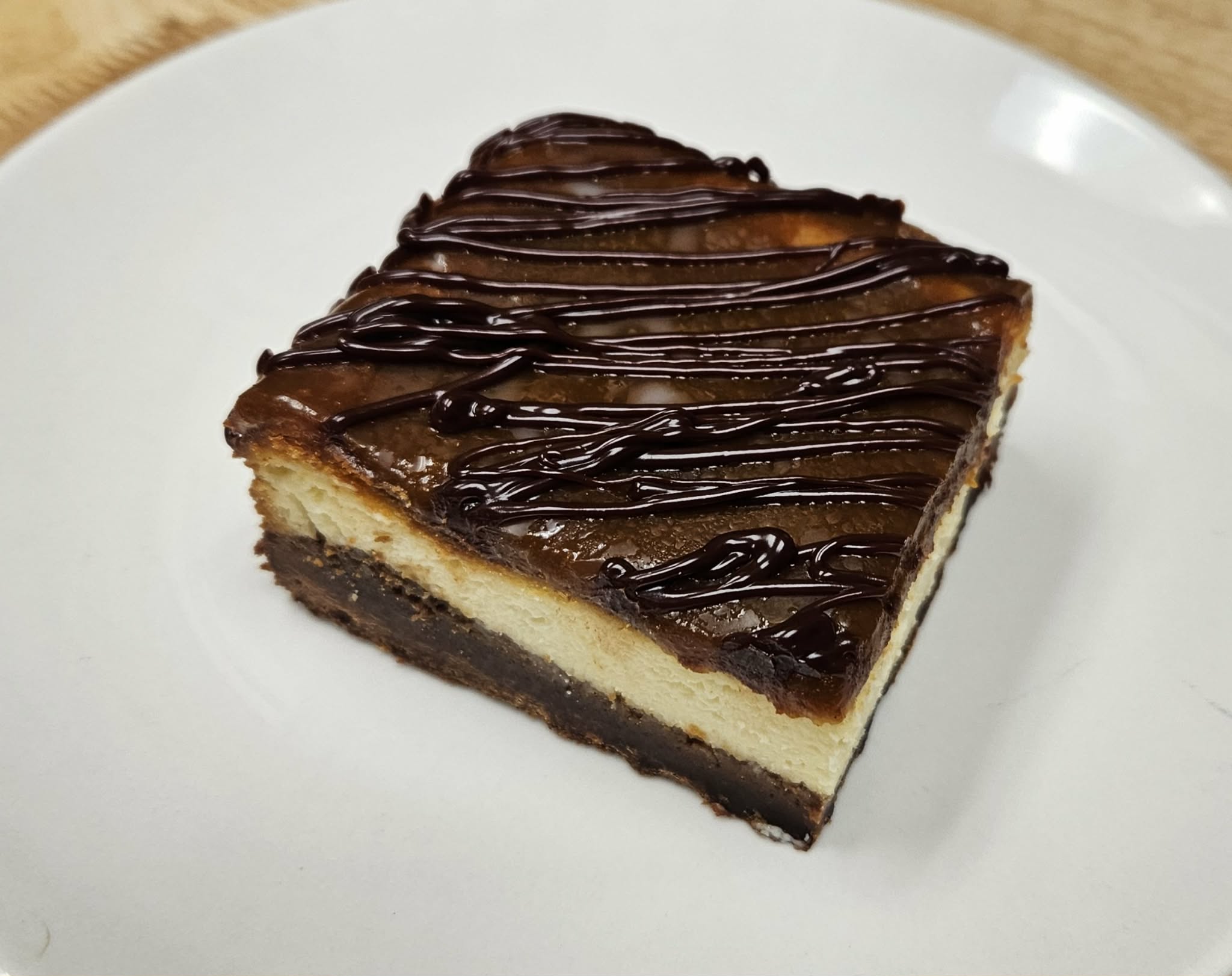 Vanilla Caramel Brownie Cheesecake Bar with Chocolate drizzle